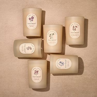 Set of six Thymes candles on a beige background