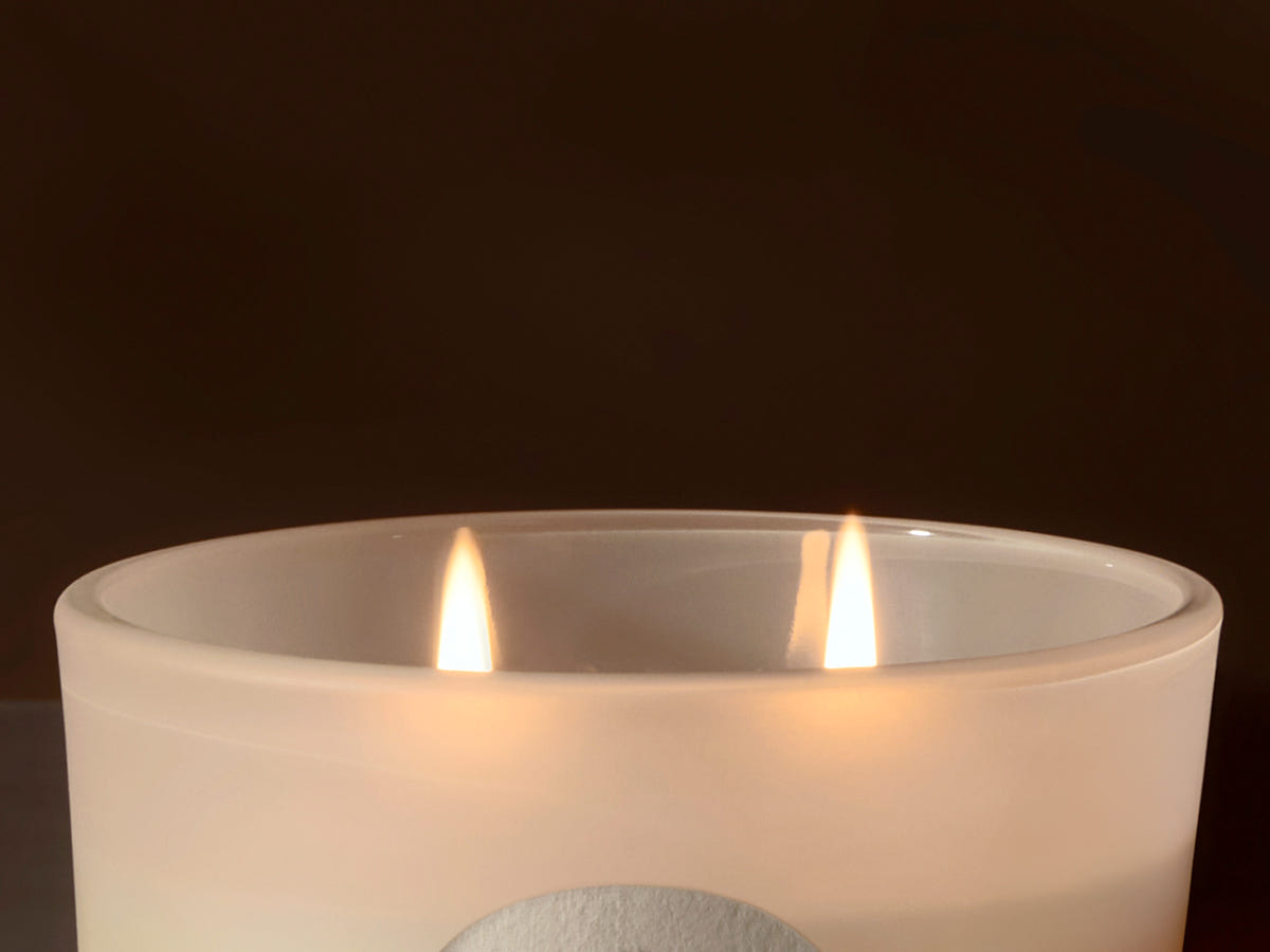 Candle in a glass jar with a dark background