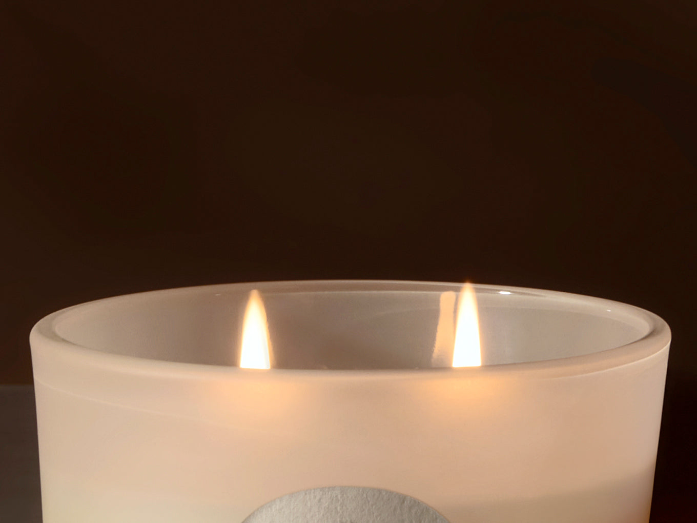 Candle in a glass jar with a dark background