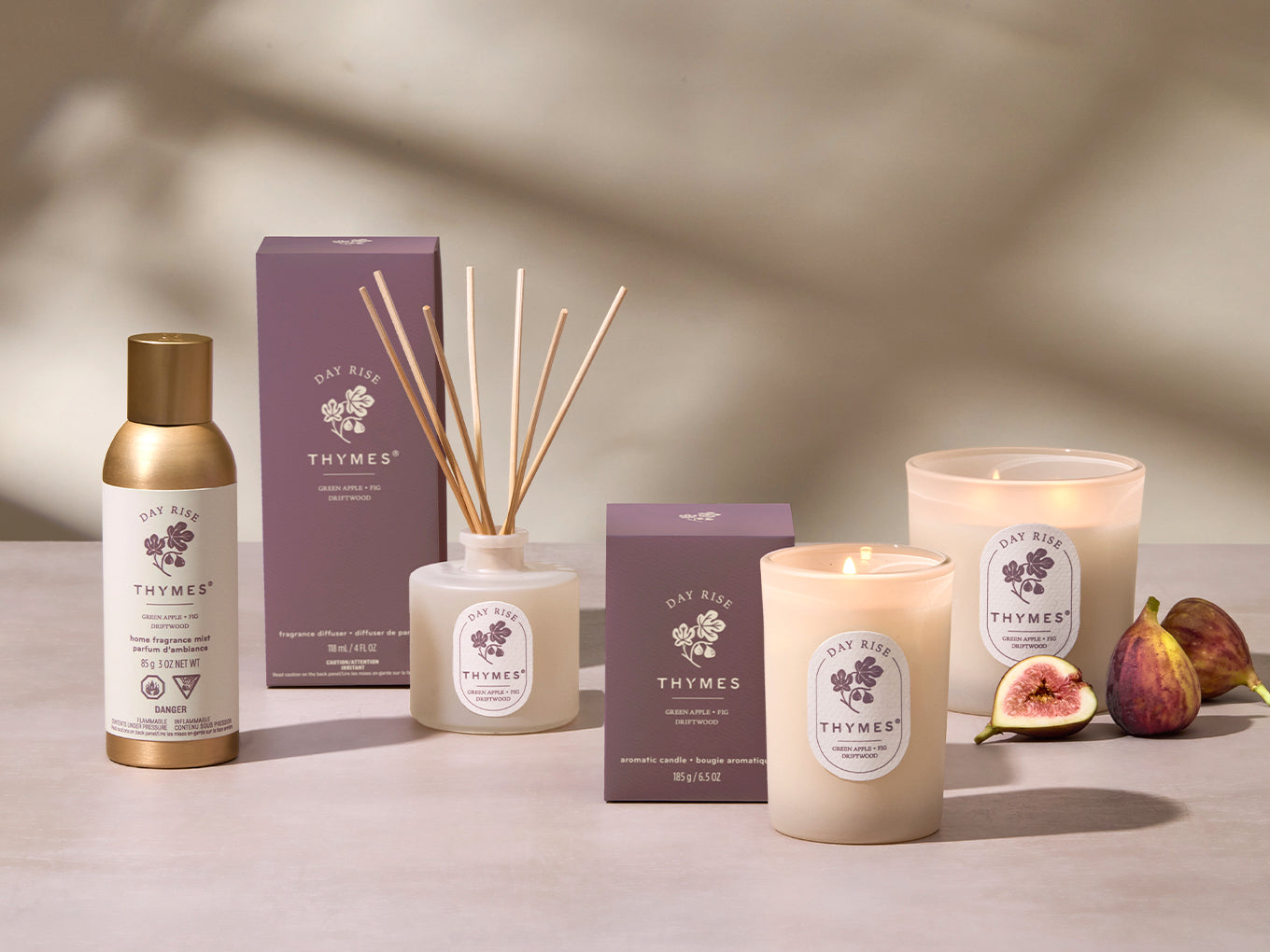 Thymes product line including candles, diffuser, and other items on a neutral background