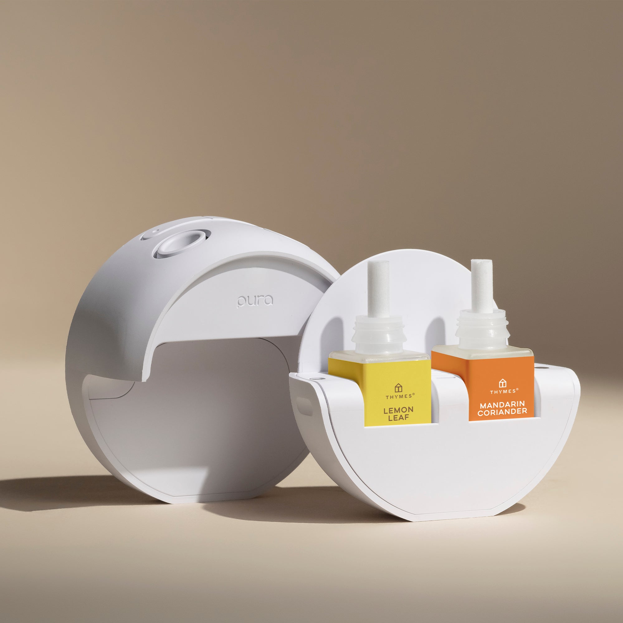 White diffuser with two bottles of essential oils on a beige background