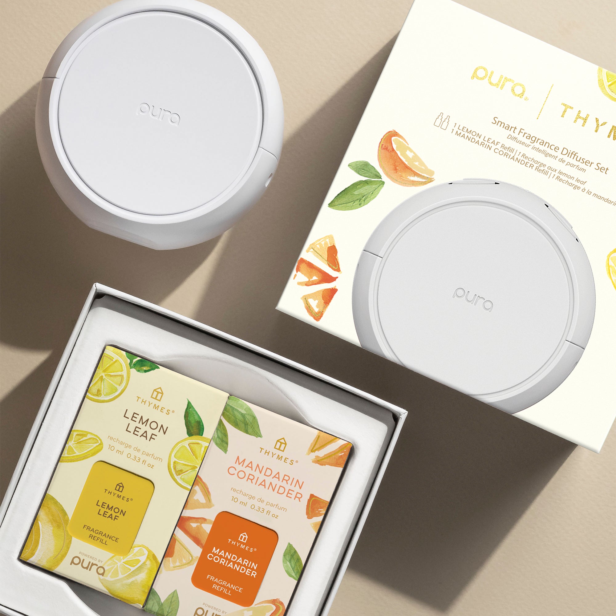 Puro smart fragrance diffuser set with lemon leaf and mandarin coriander scents on a beige background