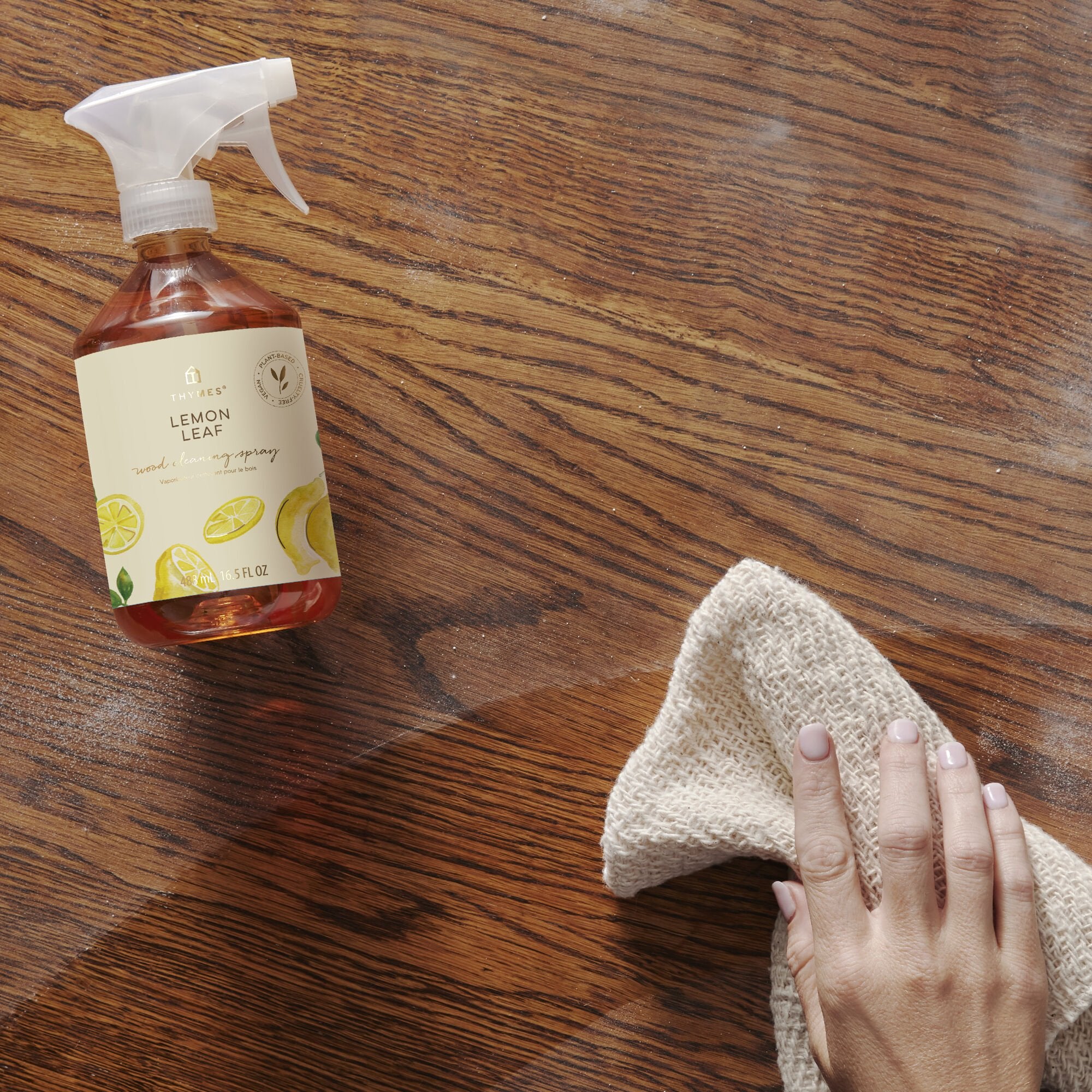 Thymes Lemon Leaf Wood Cleaning Spray on table in use