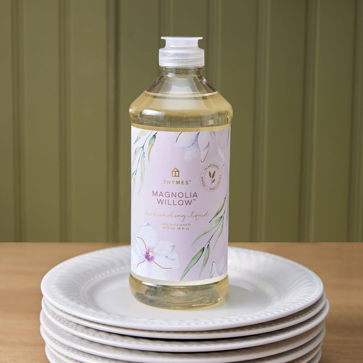 Alternate image of Thymes Magnolia Willow Dishwashing Liquid on a stack of plates