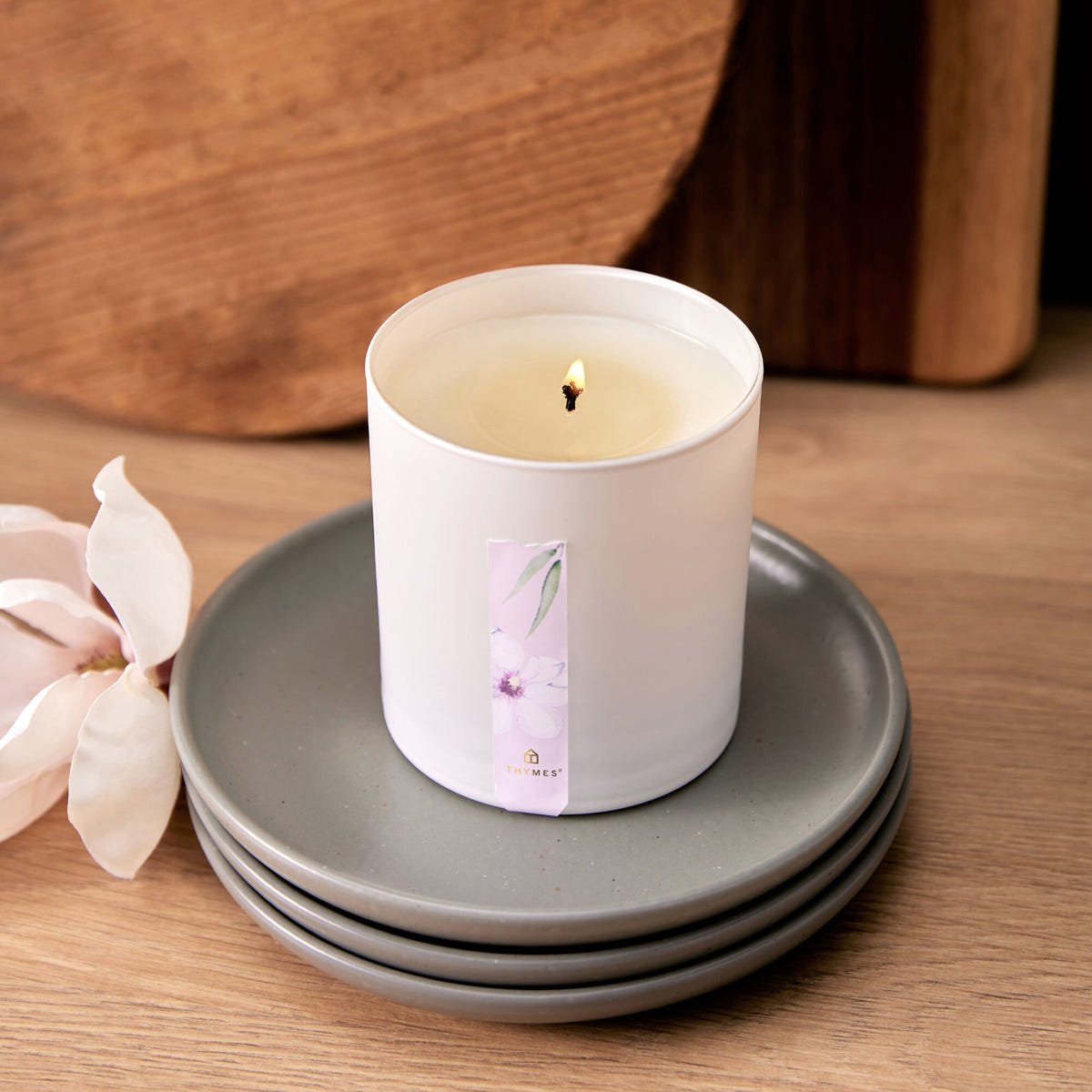 Alternate image of Magnolia Willow Poured Candle on a stack of plates