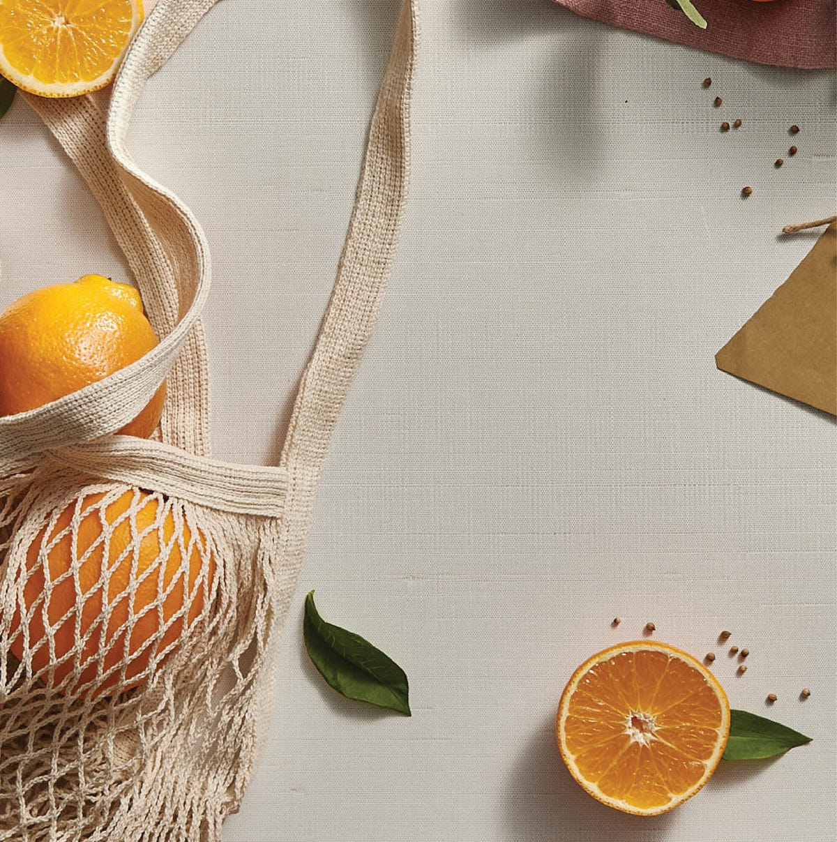 Alternate image of Thymes Mandarin Coriander Reed Diffuser Oil Refill - mandarin oranges on a table