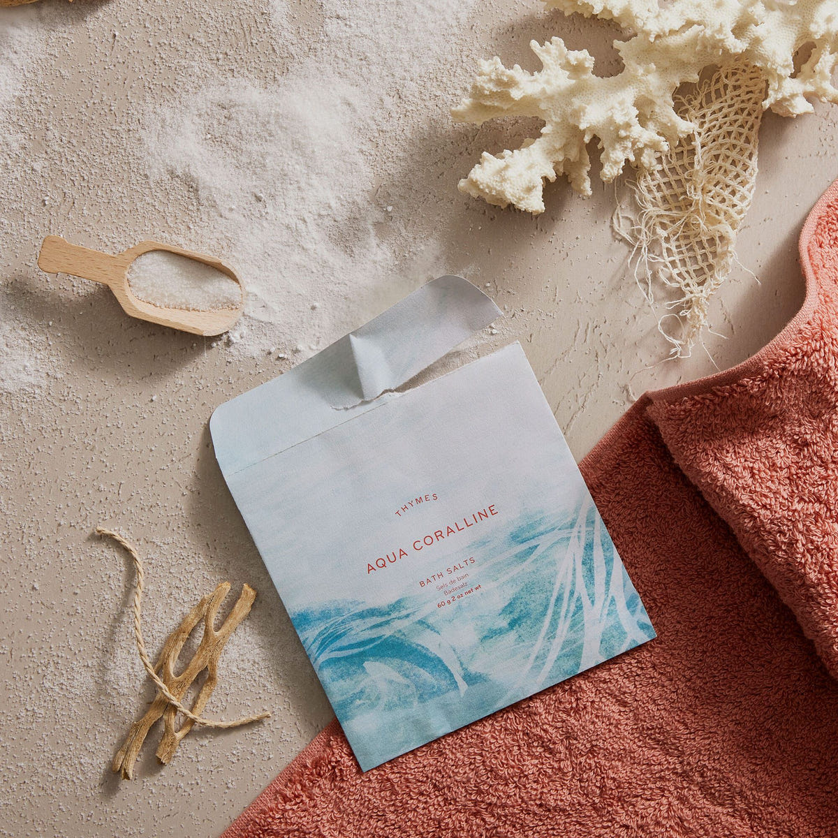 Alternate image of Thymes Neroli Sol Bath Salts Envelope for an Island Spa Experience flat lay with sand and shells