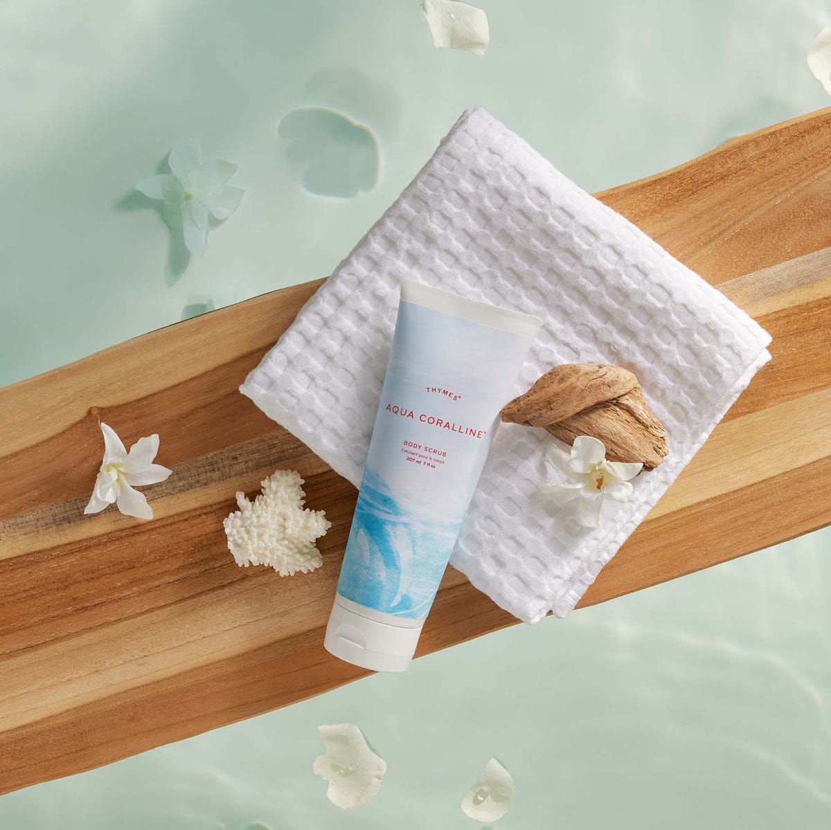 Alternate image of Thymes Aqua Coralline Body Scrub for exfoliation on wooden tray in bath