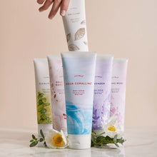 Thymes Goldleaf Gardenia Body Scrub for exfoliation standing next to other Thymes Body Scrubs