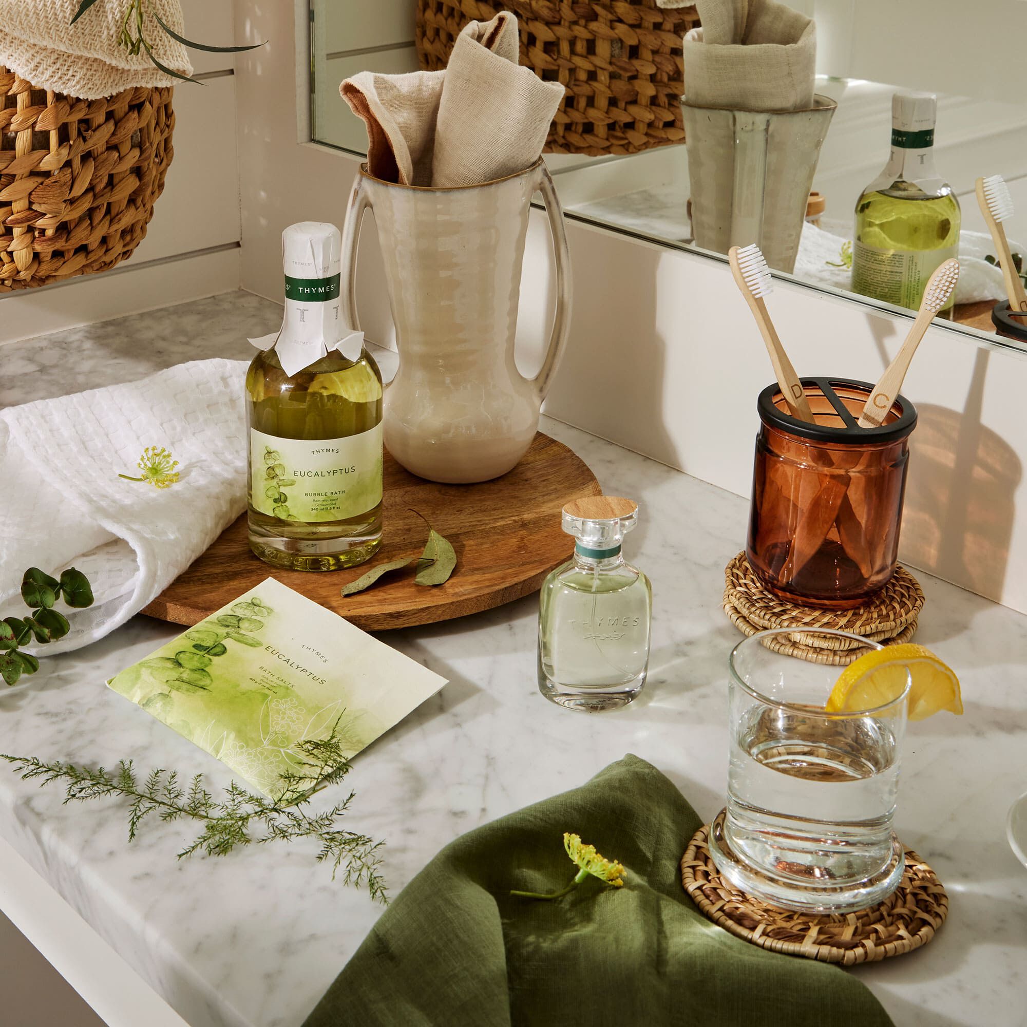 Thymes Eucalyptus Bath Salts on countertop with other Thymes Eucalyptus products