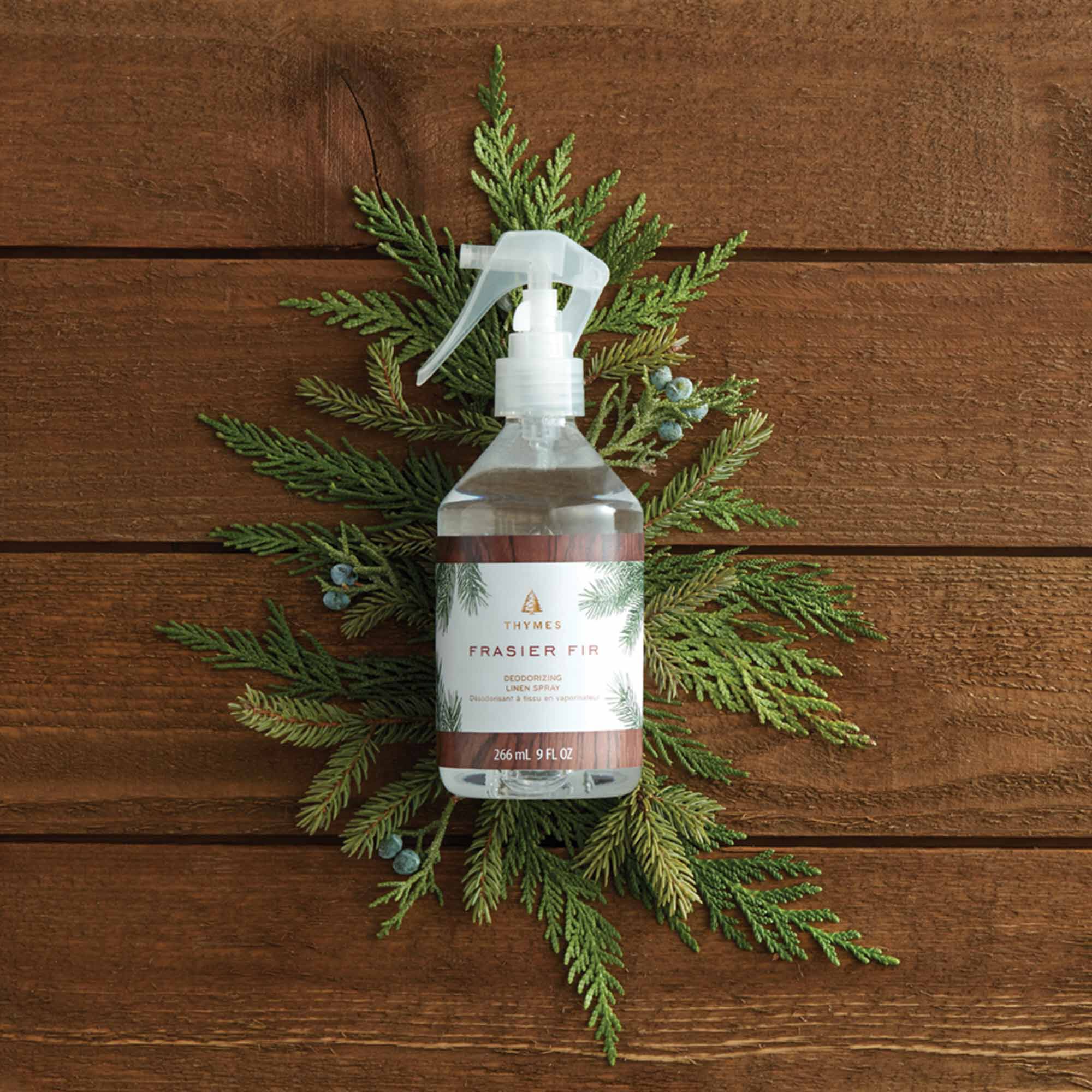 Thymes Frasier Fir Deodorizing Linen Spray Surrounded by Pine Stems