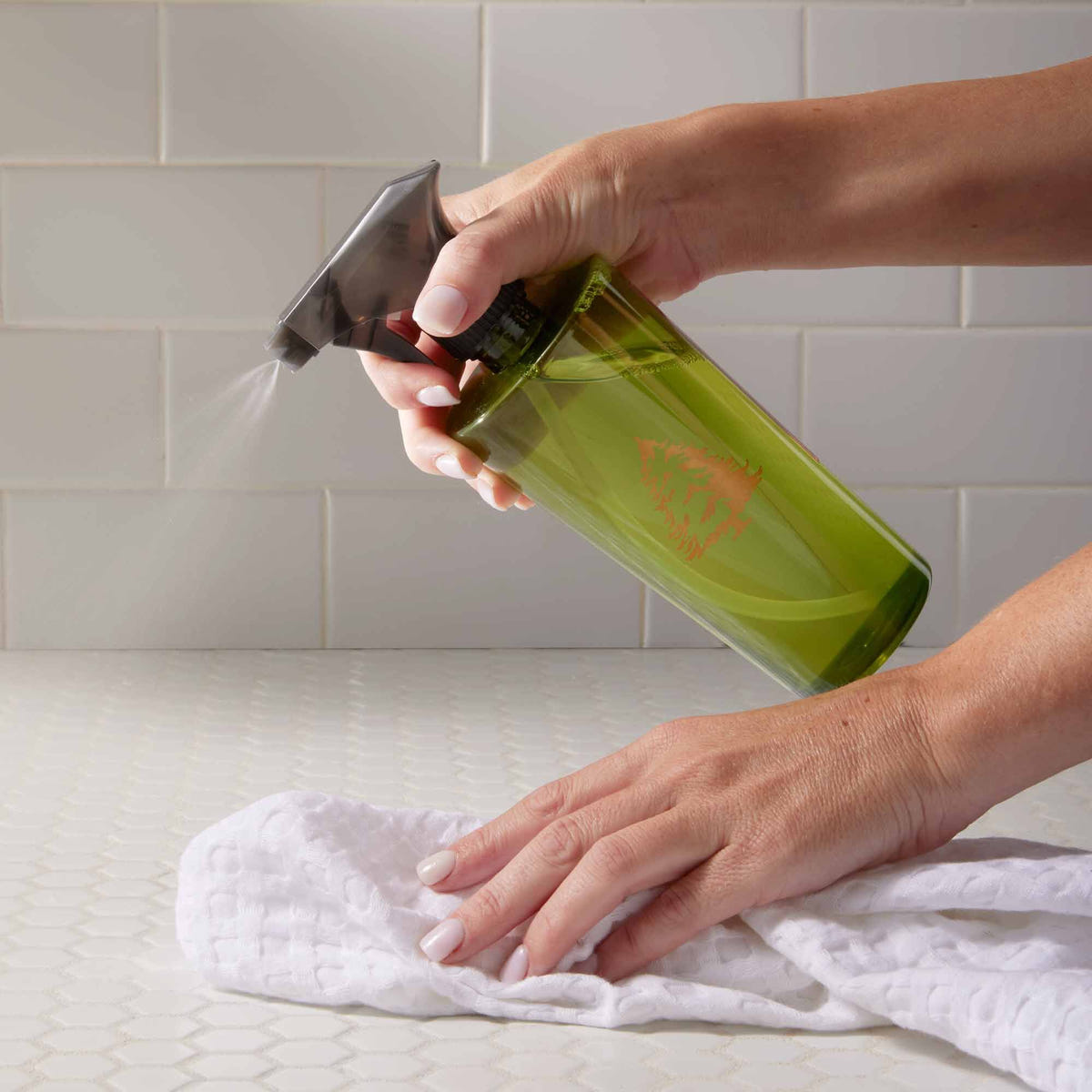 Alternate image of Holding Towel and Spraying Counter with Thymes Frasier Fir All-Purpose Cleaning Spray
