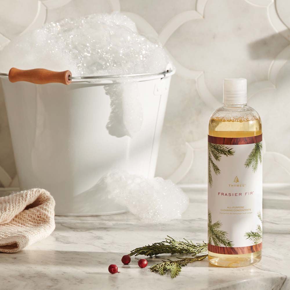 Alternate image of Thymes Frasier Fir All-Purpose Cleaning Concentrate on kitchen counter next to a warm bucket of water