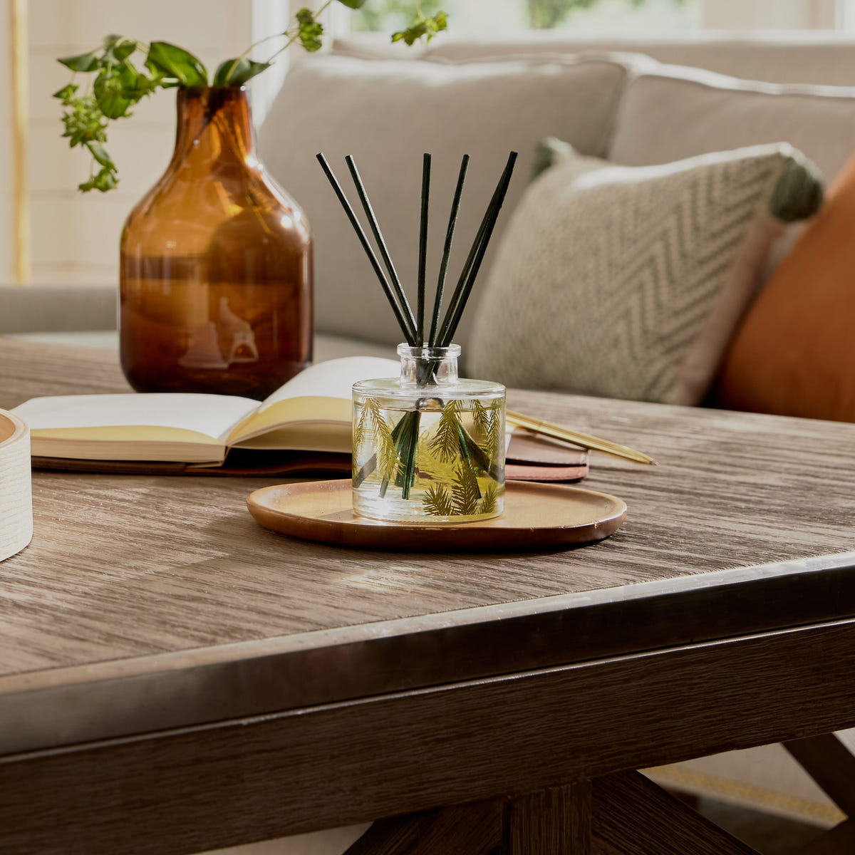 Alternate image of Frasier Fir Petite Pine Needle Reed Diffuser on coffee table