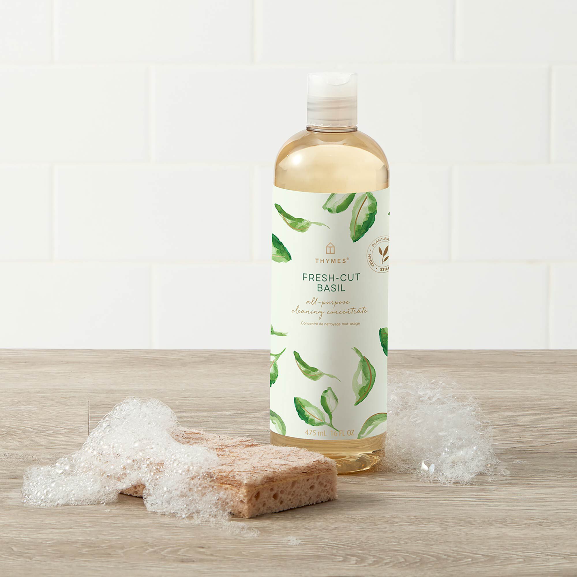 Thymes Fresh-Cut Basil All-Purpose Cleaning Concentrate for Floors and Surfaces with bubbles and sponge