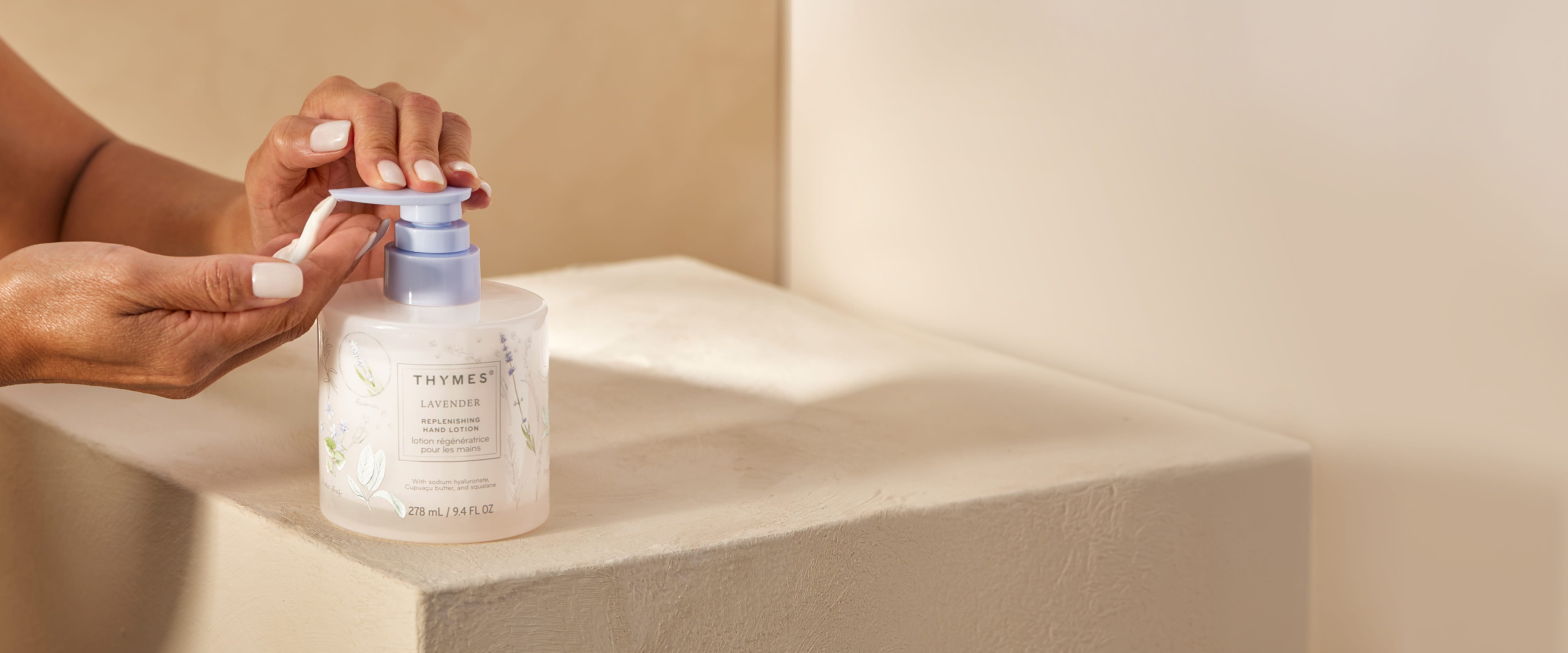 Hand holding a bottle of Lavender Replenishing Hand Lotion