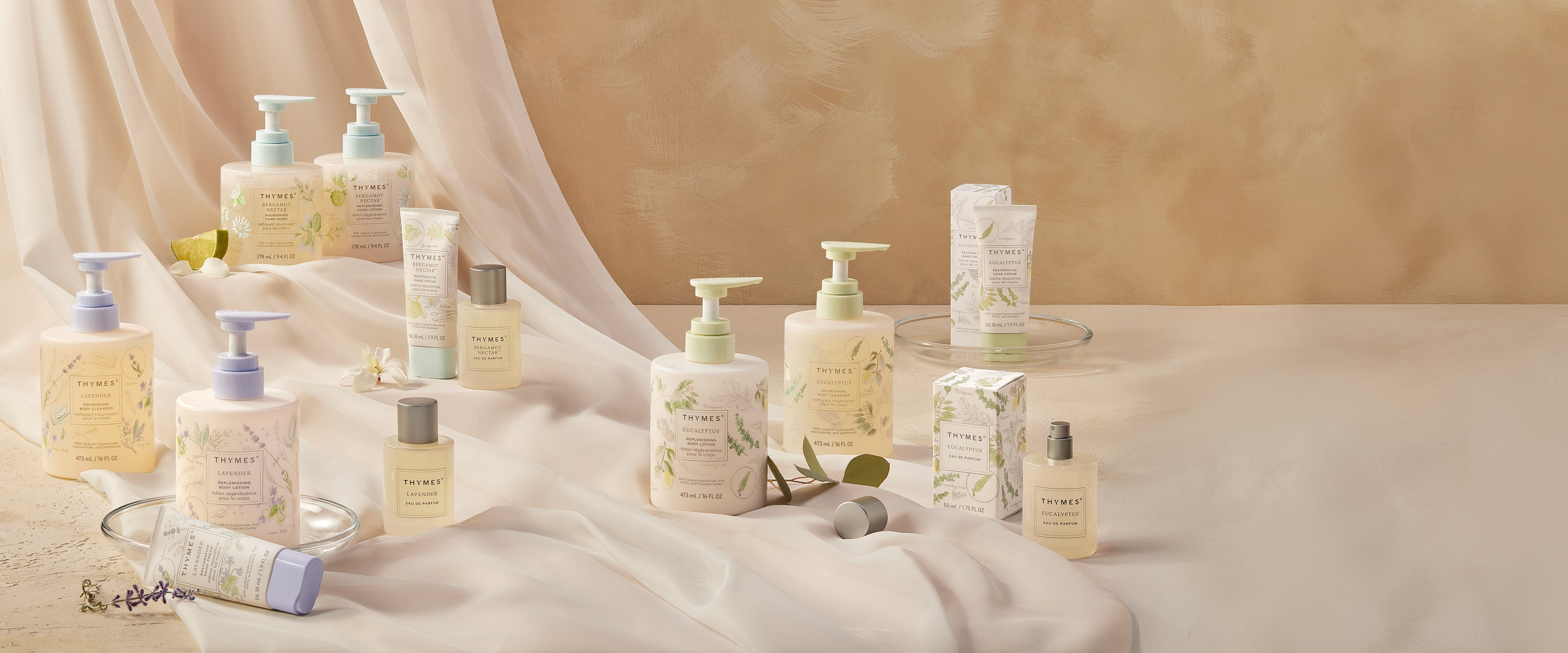 Collection of bath and body products on a soft fabric background