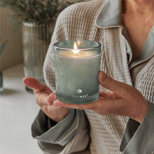 Thymes Highland Frost Boxed Votive Candle in hand