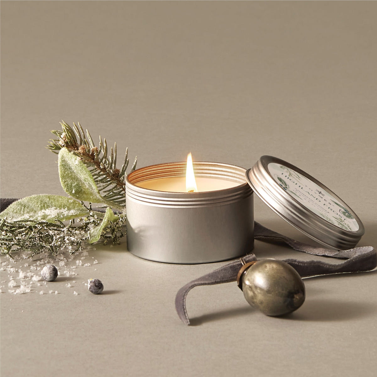 Alternate image of Thymes Highland Frost Travel Tin Candle open and lit 