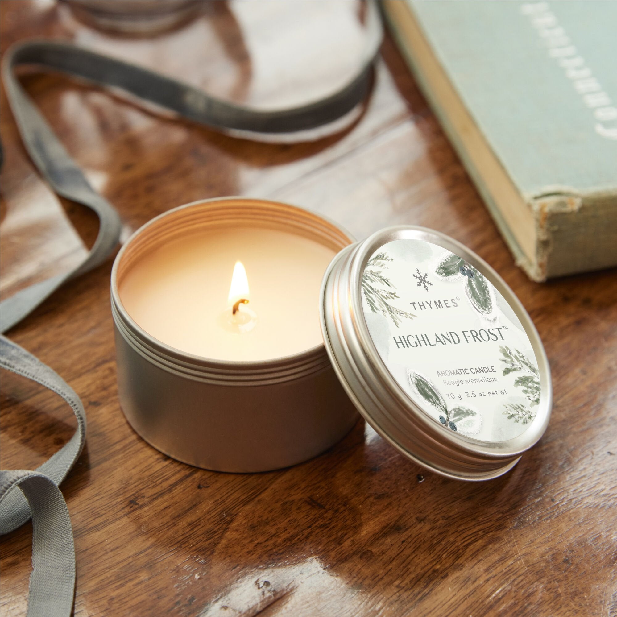 Thymes Highland Frost Travel Tin Candle lit from above