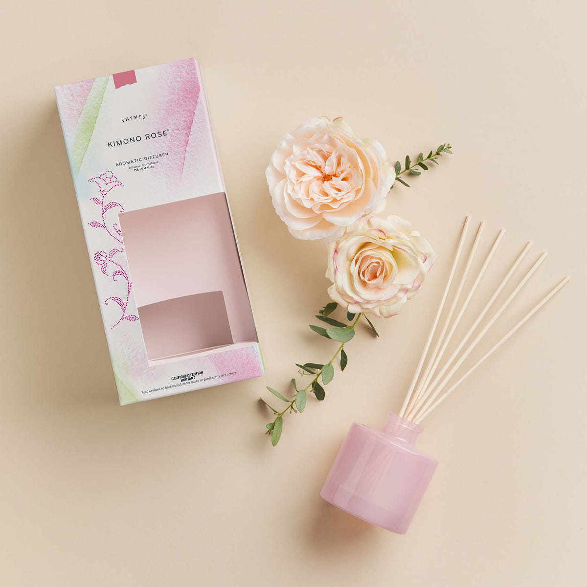Alternate image of Thymes Kimono Rose Petite Reed Diffuser next to roses