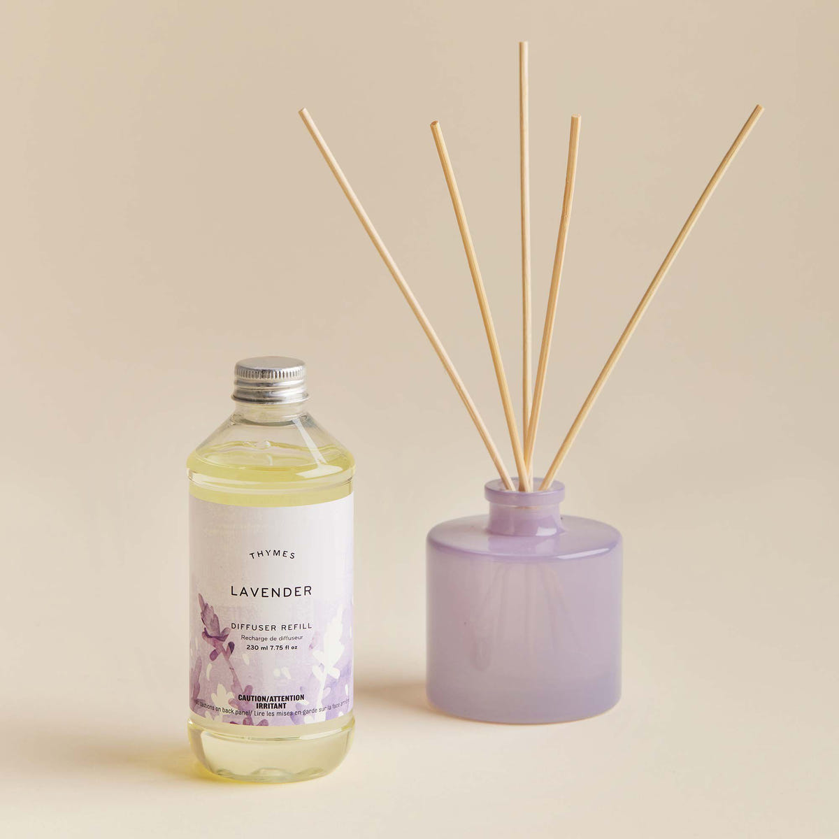 Alternate image of Thymes Lavender Diffuser Oil Refill next to petite lavender diffuser