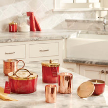 Thymes Simmered Cider Harvest Red 4-Wick Candle on kitchen counter with other Thymes Simmered Cider Red Harvest Candles