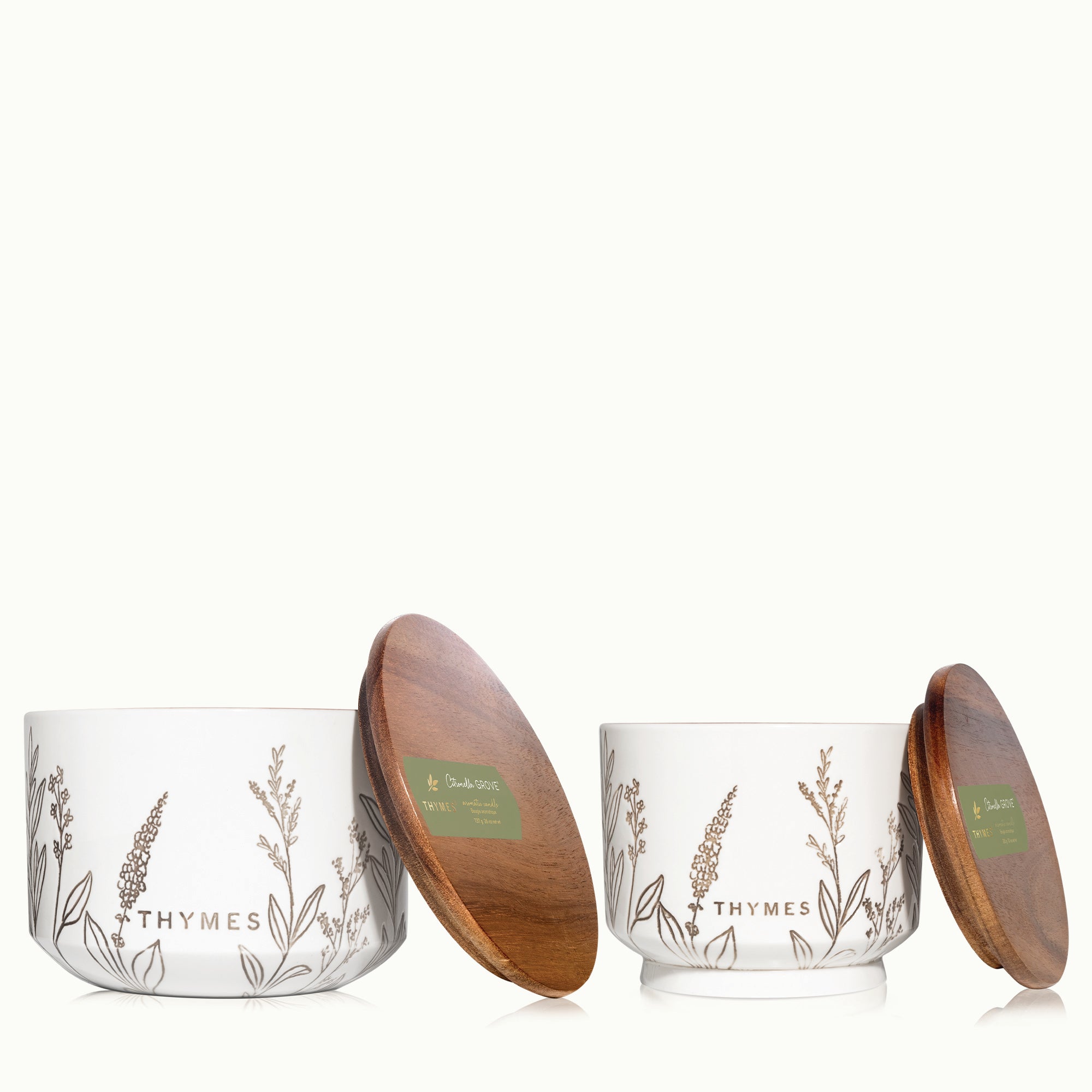 Two Thymes candles with wooden lids on a white background