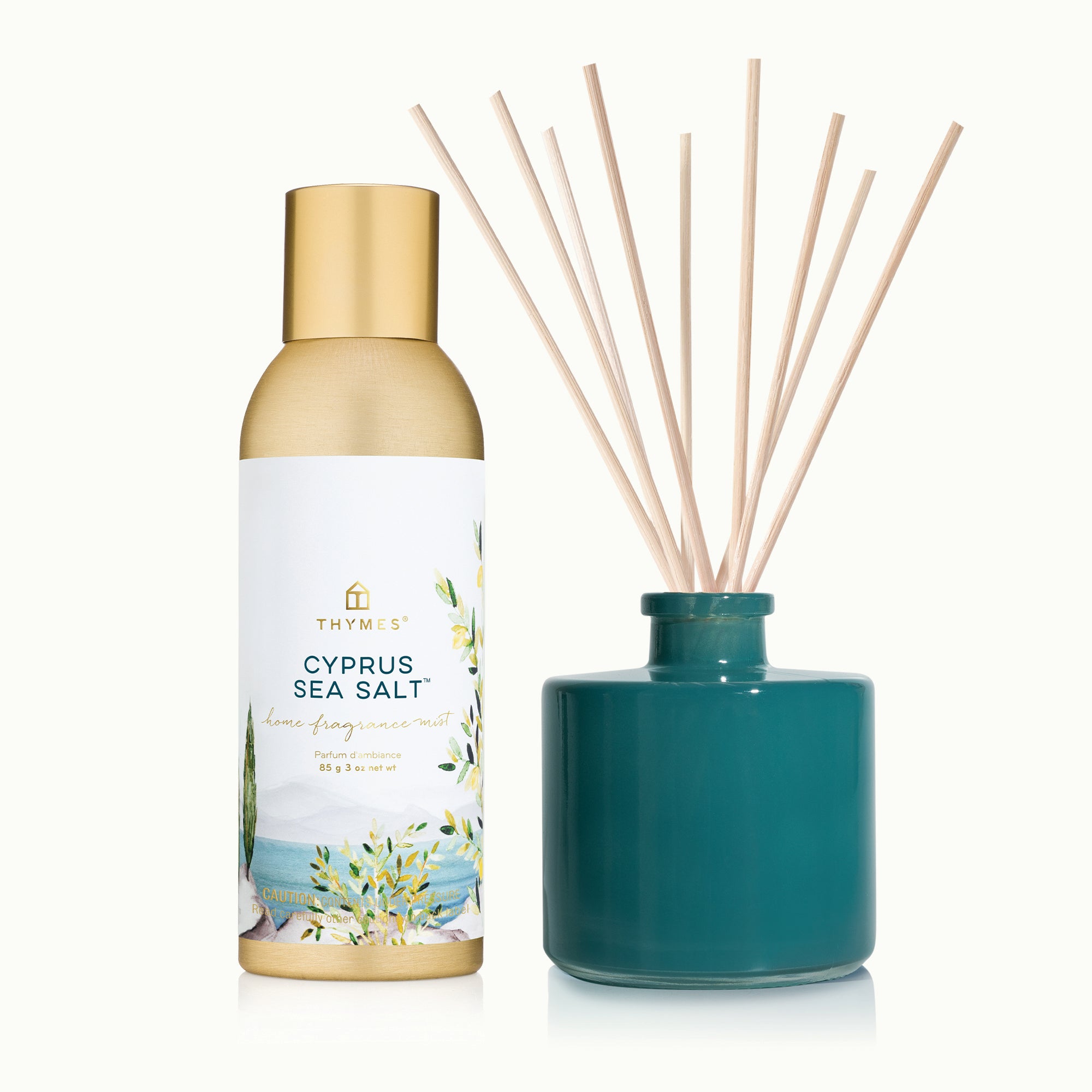 Thymes Cypress Sea Salt diffuser bottle and green diffuser with reeds on a white background