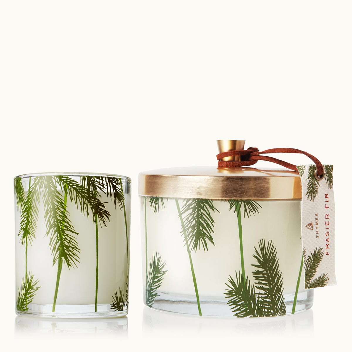 Candle with palm tree design and decorative lid on a white background