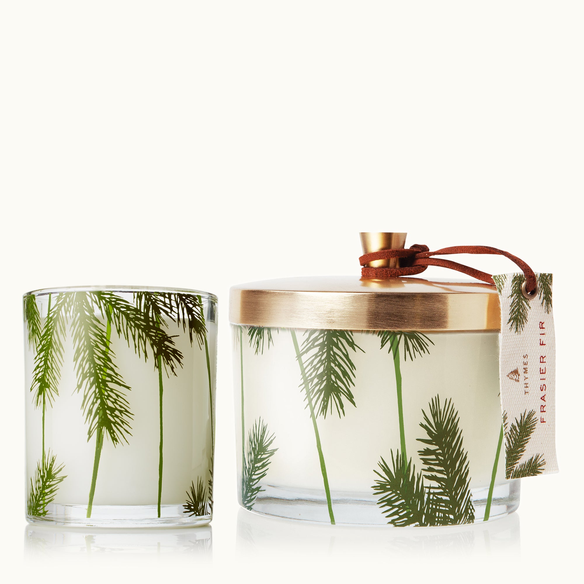 Candle with palm tree design and decorative lid on a white background