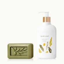 Olive leaf soap bar and lotion bottle on a white background