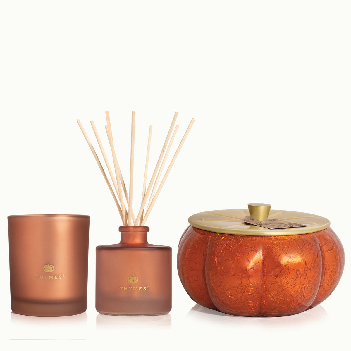 Set of Thymes products including a  6.5 oz Poured Candle, the 13 oz Poured Candle, and the Petite Reed Diffuser on a white background