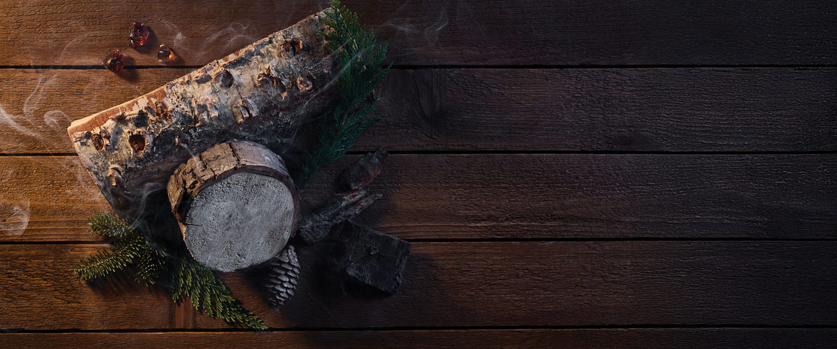 Wooden block with a round stone on a dark wooden surface