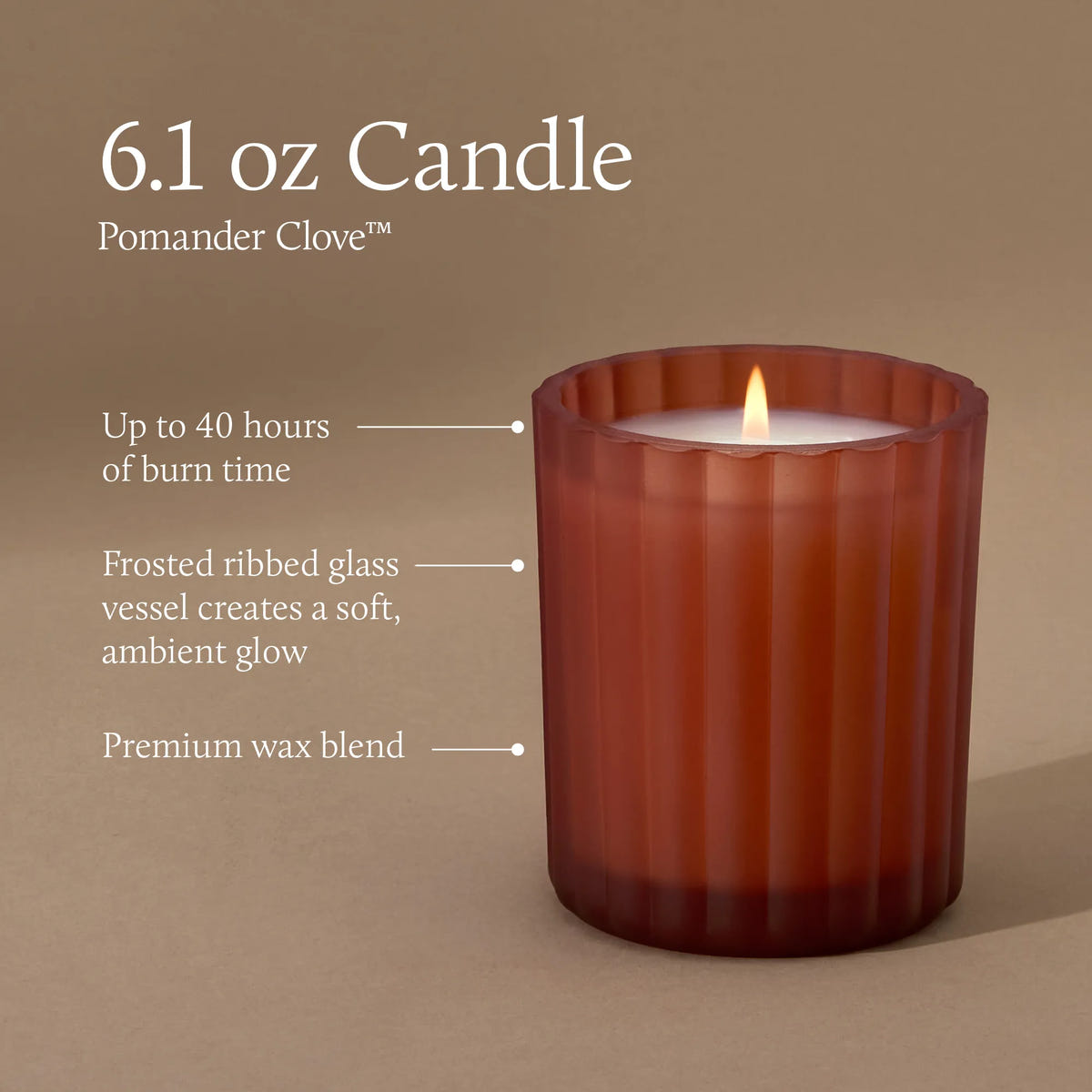 A 6.1 ounce candle in a frosted, matte, sienna orange glass vessel with a lit flame. Text indicates a burn time of up to 40 hours, a frosted ribbed glass vessel that creates a soft, ambient glow, and premium wax blend.