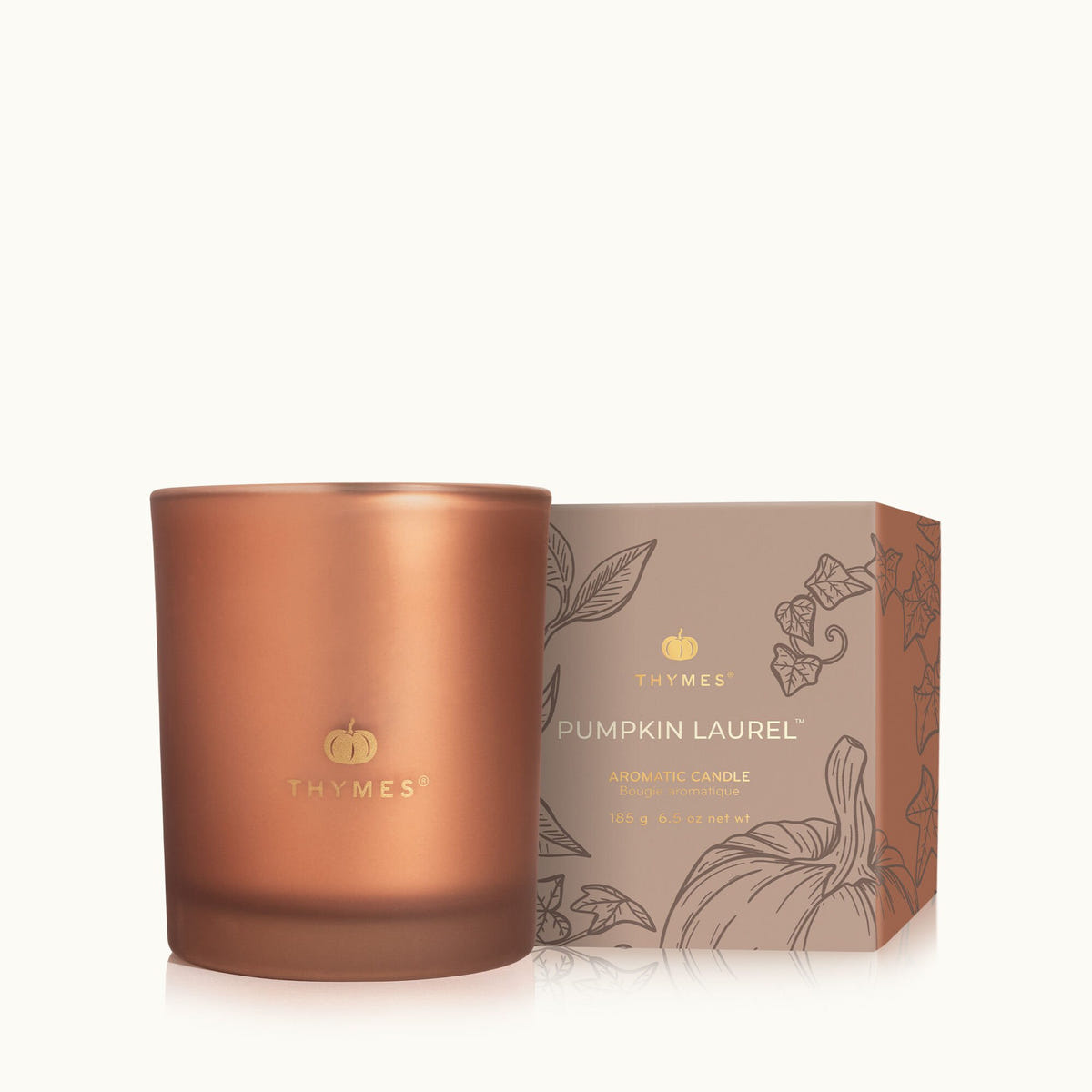 Alternate image of 6.5 oz Poured Pumpkin Laurel Candle next to its packaging on a white background